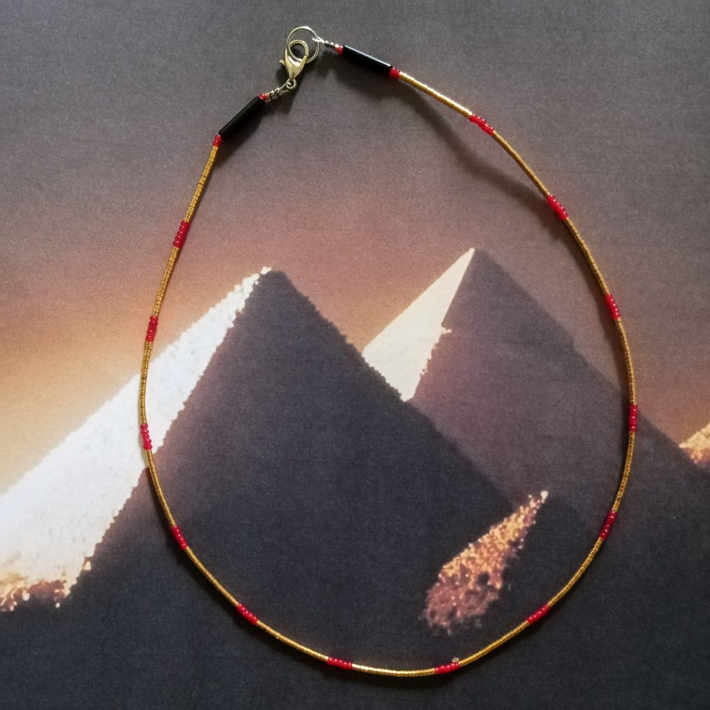Beaded necklace with gold-leaf-covered haematite and antique Naga seed beads wearable art by Khumoetsile Seamogano
