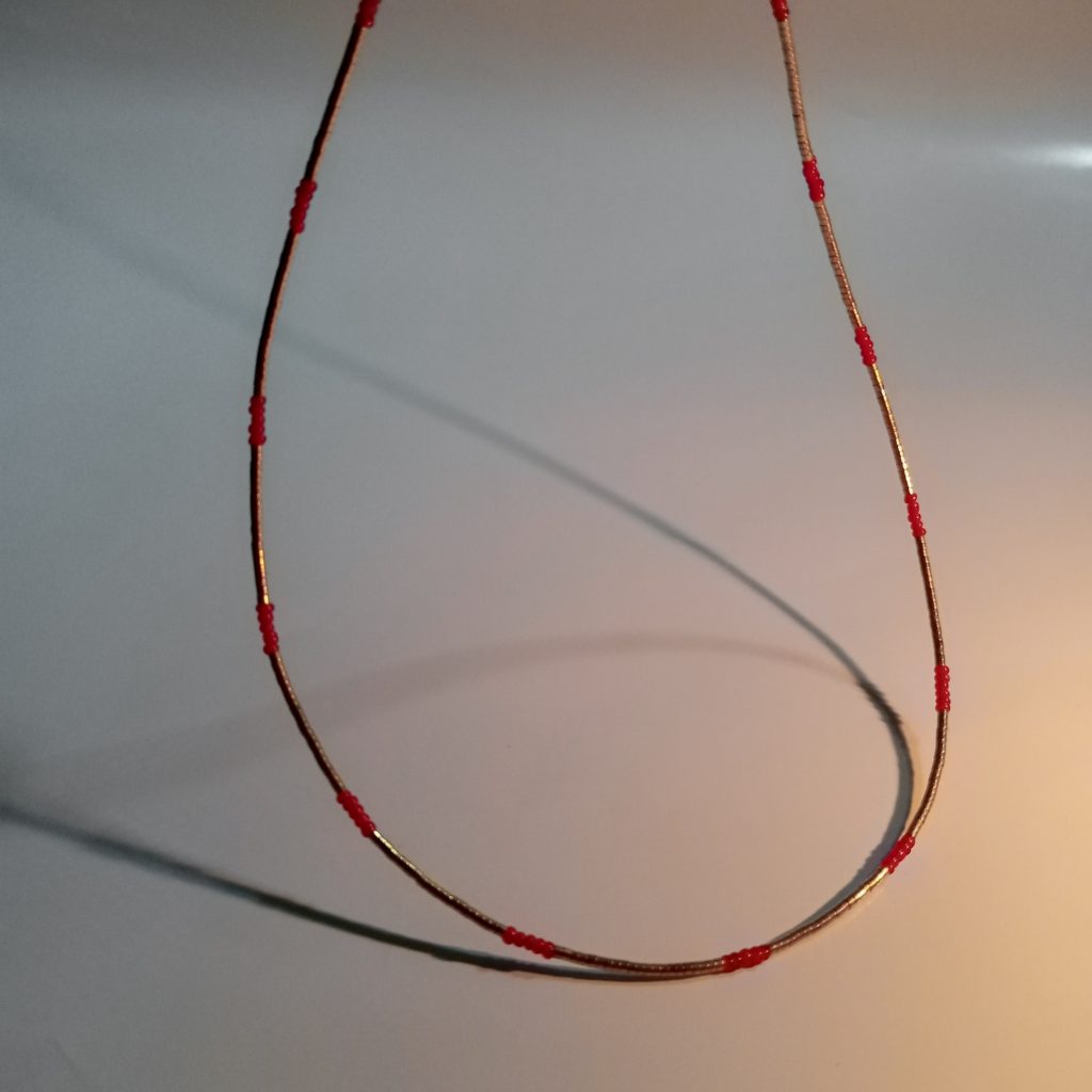 Beaded necklace with gold-leaf-covered haematite and antique Naga seed beads