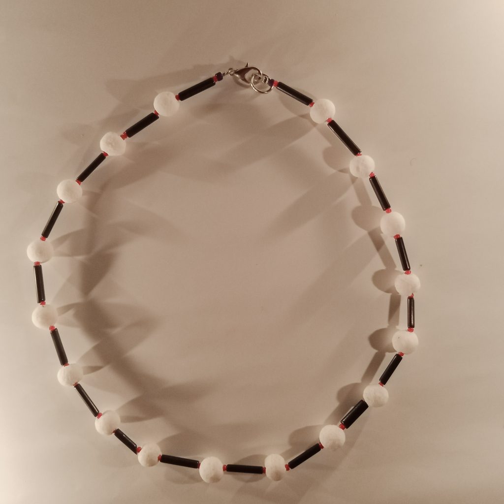 Beaded necklace made with red antique Naga seed beads, basalt and black onyx